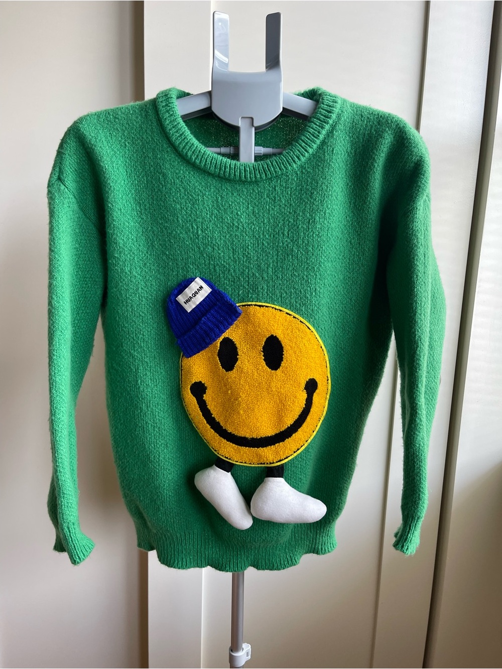 Fun Green Sweater with Yellow Smiley Appliqué, Blue Beanie and Dangling Feet!